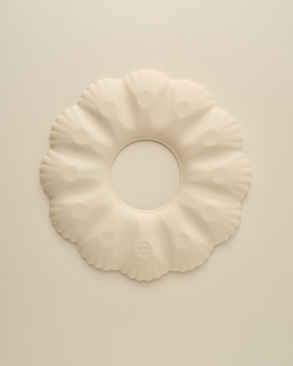 Underside of the Natural White oyster plate, matte unglazed porcelain with the Nattier maker's mark