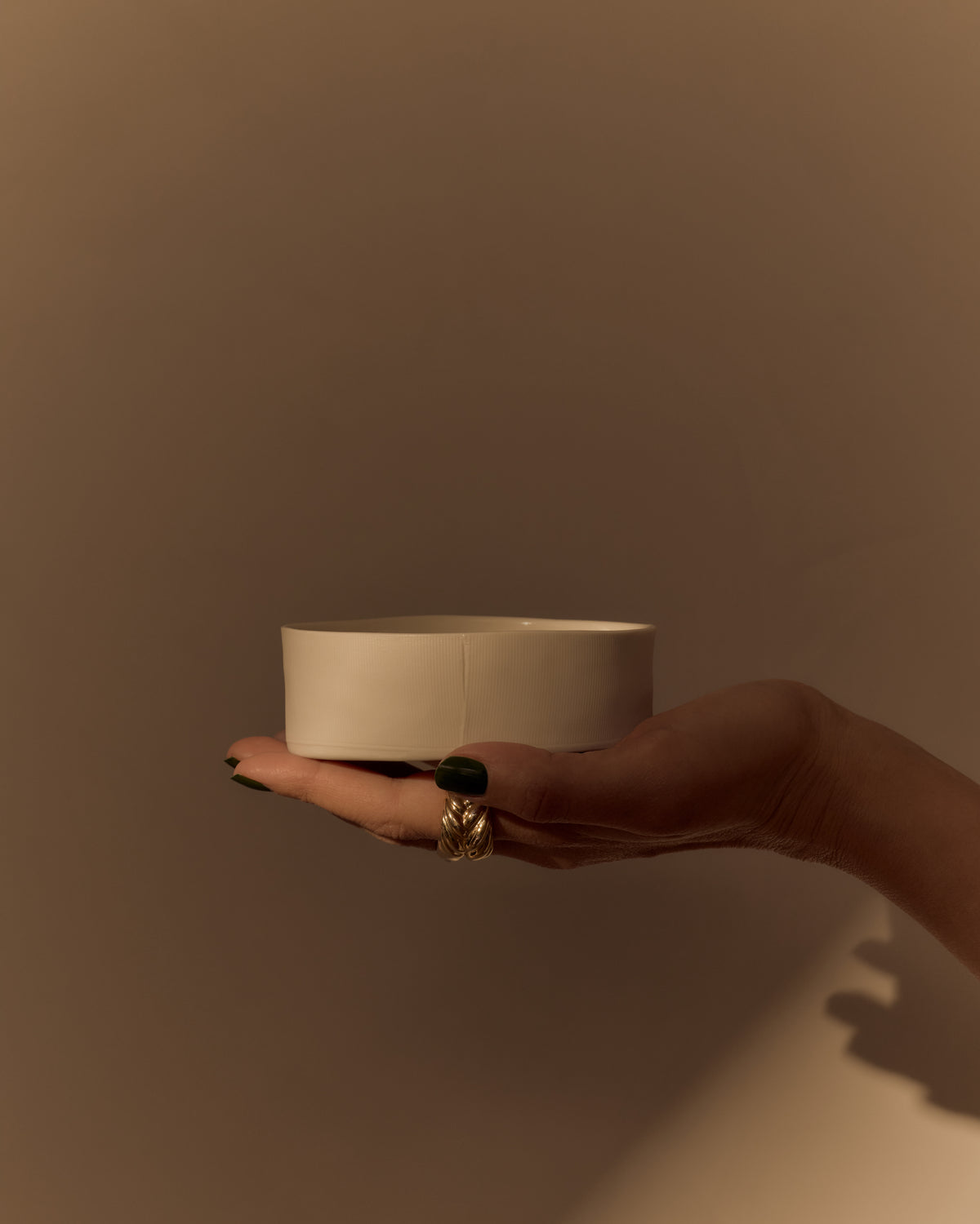 Ribbons Mini Bowl in Natural White, held in one hand