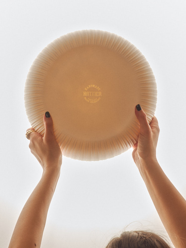 Banksia Bowl held up to show the maker's mark. Photograph by Sarah Forgie