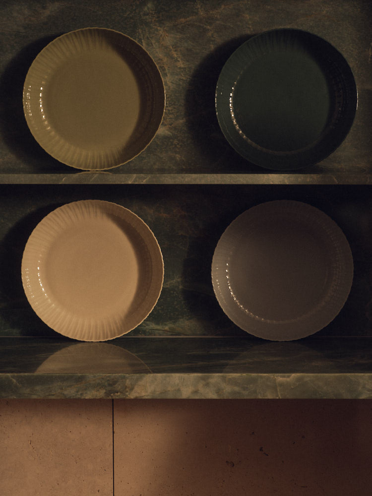 Four Banksia Bowls in four colours on shelves. Photograph by Sarah Forgie