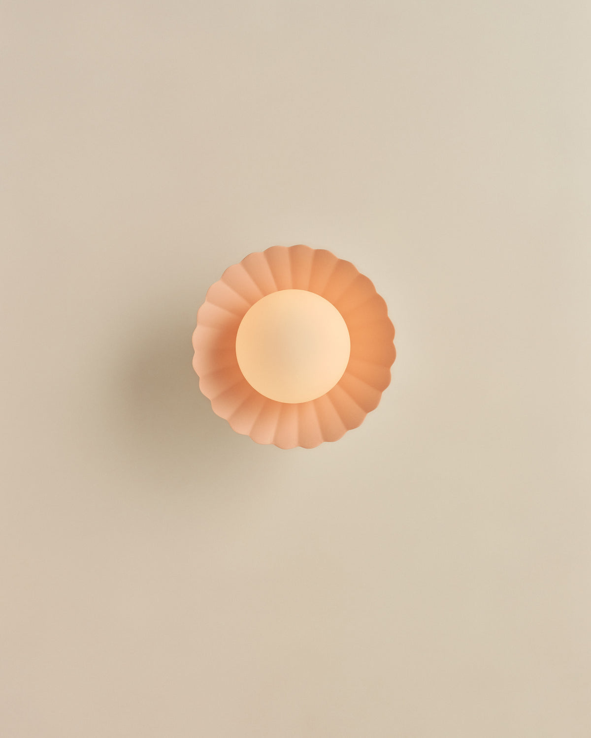 Daisy Wall Sconce in Whispery Pink, lit