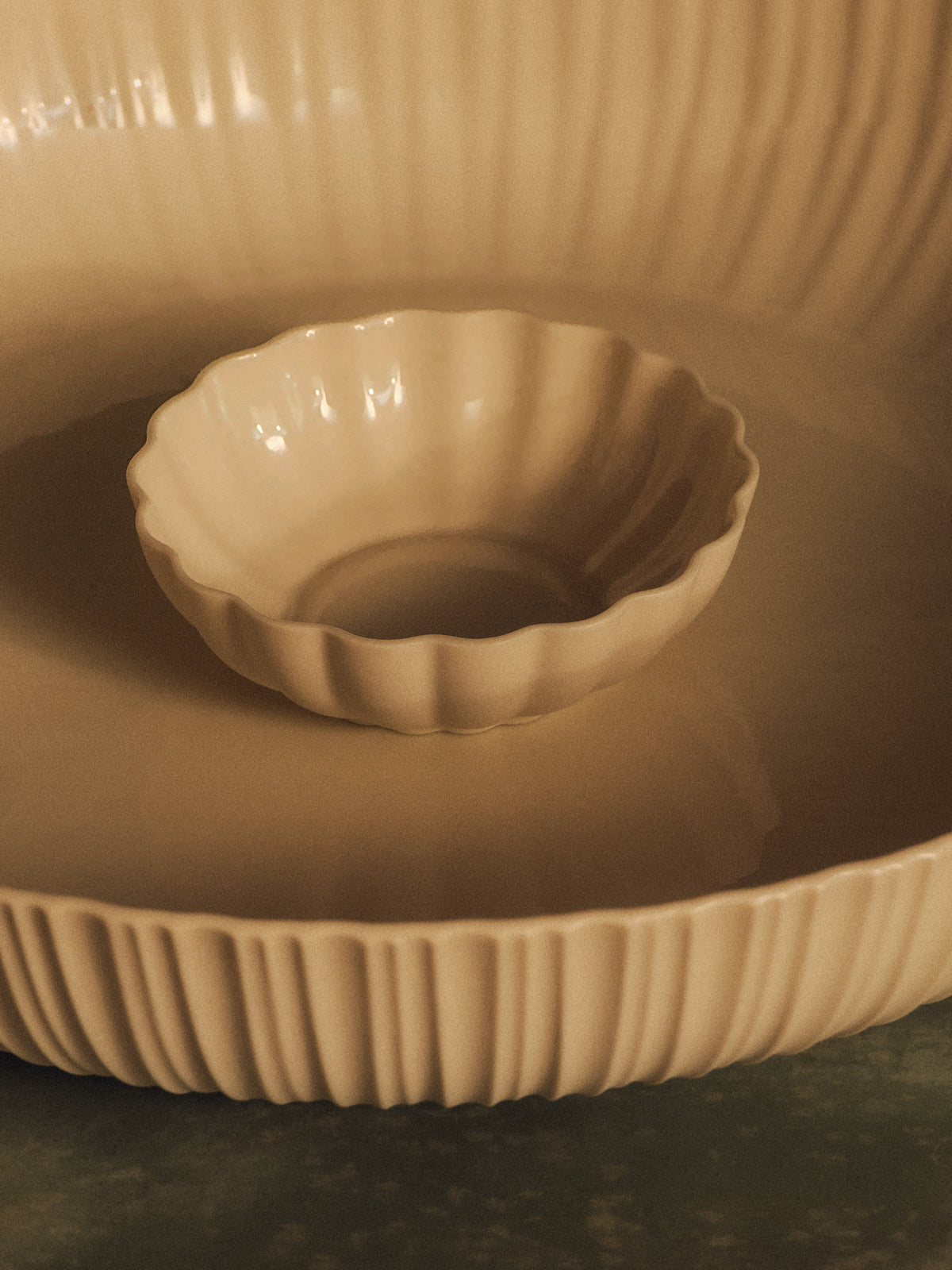 Fern Nesting Bowl 10cm Extra Small in Natural White, sitting in the Banksia Bowl on green marble. Photograph by Sarah Forgie