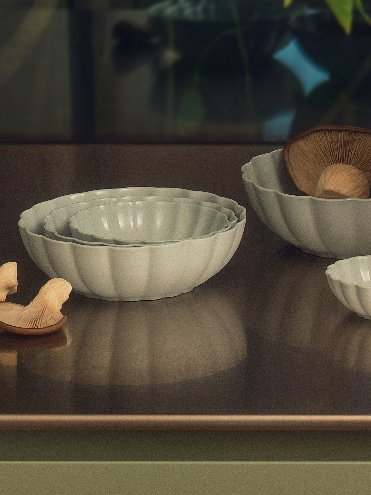 Fern Nesting Bowls in Light Blue Grey on a kitchen bench with mushrooms. Photograph by Sarah Forgie