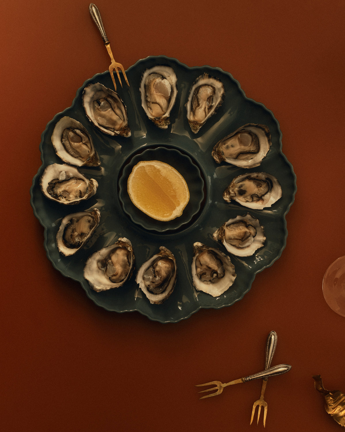 Mother of Pearl Oyster Plate, Dozen, in Dark Forest Green with oysters and a lemon. Photograph by Sarah Forgie