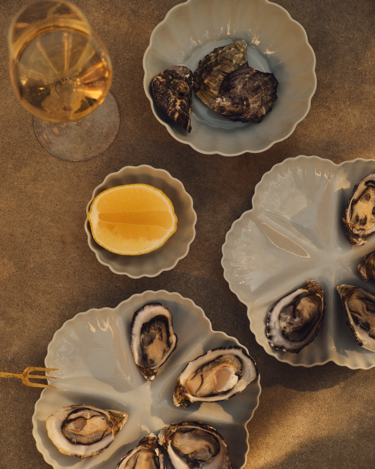 Mother of Pearl Oyster Plate, Half Dozen, in Light Blue Grey with oysters and a lemon. Photograph by Sarah Forgie